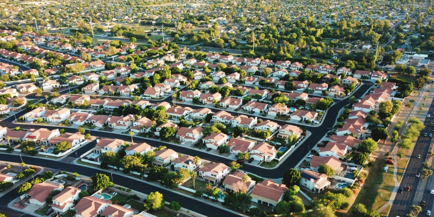 Aerial view of a Southwest desert subdivision of single story tile roof homes on curved streets, the housing type that fills the North Las Vegas neighborhoods closest to Nellis Air Force Base