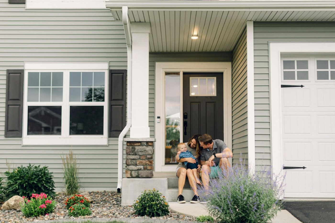 Young Las Vegas family with their baby in the yard of their first VA-loan home